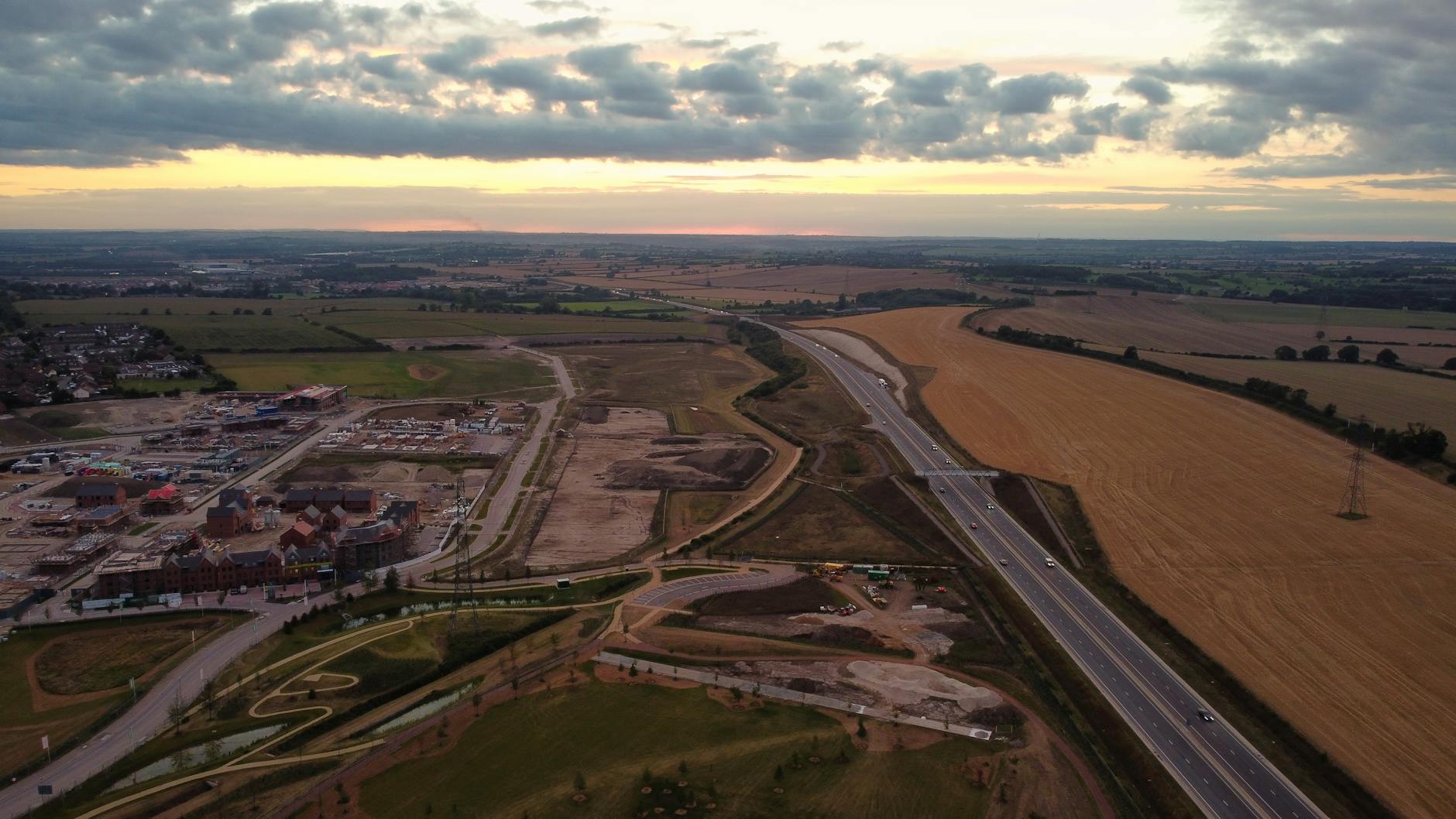 Aerial shot of rural landscape showing fields and roads in Central Bedfordshire, UK, at sunset.