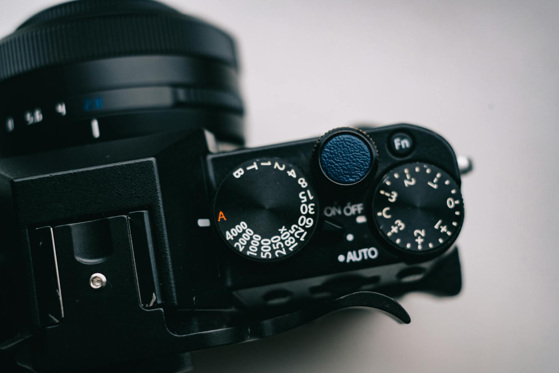 A detailed close-up shot of a camera's control dials and settings, showcasing manual adjustments.